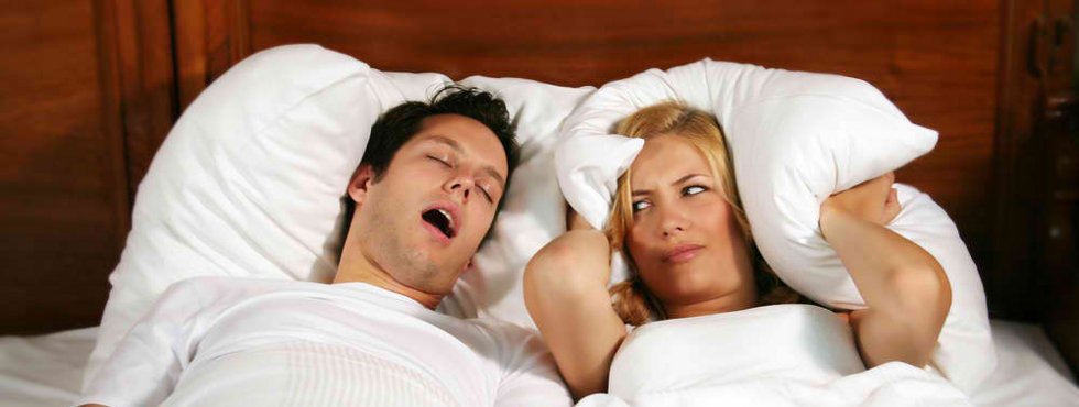 Snoring Man with frustrated bed partner